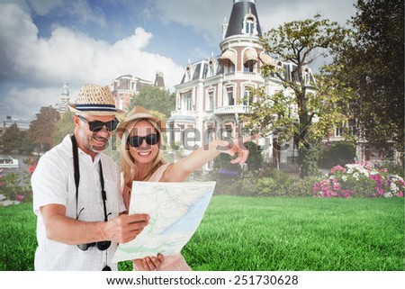 Happy tourist couple using map and pointing against sunny day by the river