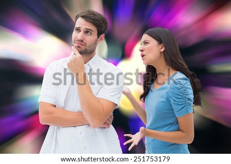 Angry brunette shouting at boyfriend against twinkling yellow and purple lights