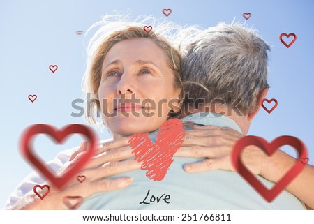 Senior woman hugging her partner against love heart