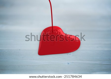 Liquid heart pouring against bleached wooden planks background