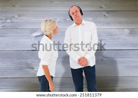 Annoyed woman being ignored by her partner against bleached wooden planks background