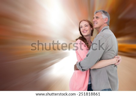 Casual couple hugging and smiling against blurry new york street