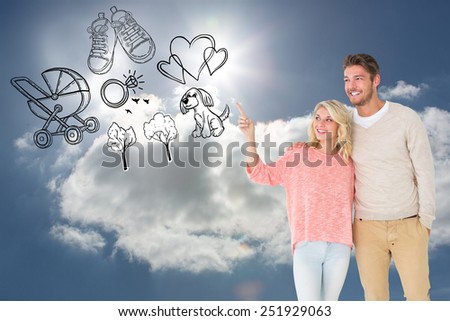 Attractive couple smiling and walking against blue sky with clouds and sun