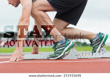 Side view of a man ready to race on running trac against stay motivated