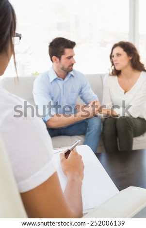 Couple talking with their psychologist in the office