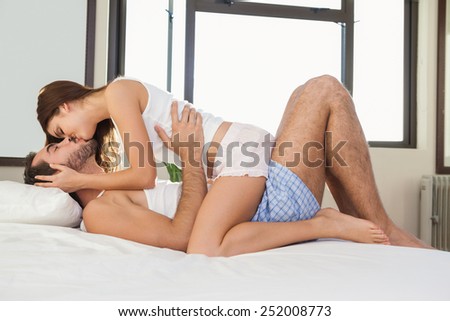 Young couple having fun in bed at home in bedroom