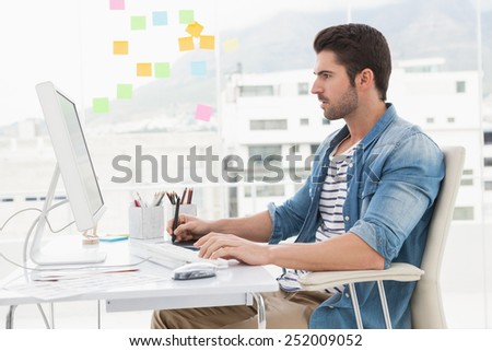 Concentrated designer using computer and digitizer in the office