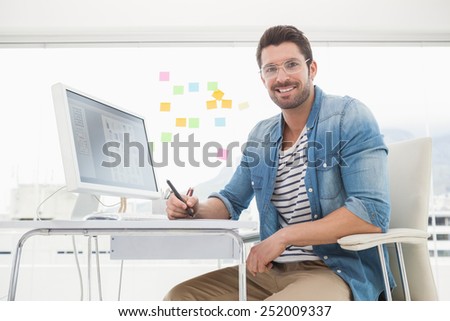 Portrait of smiling designer with digitizer in the office