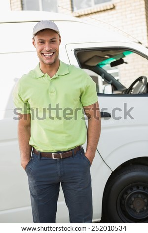 Three quarter length portrait of smiling man in front of delivery van