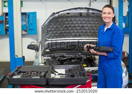 Mechanic smiling at the camera at the repair garage