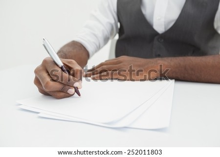 Businessman writing notes on paper in the office