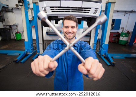 Mechanic smiling at the camera at the repair garage