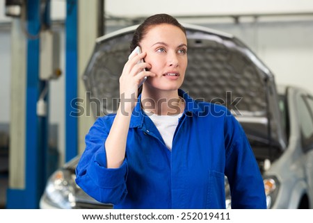 Mechanic talking on the phone at the repair garage