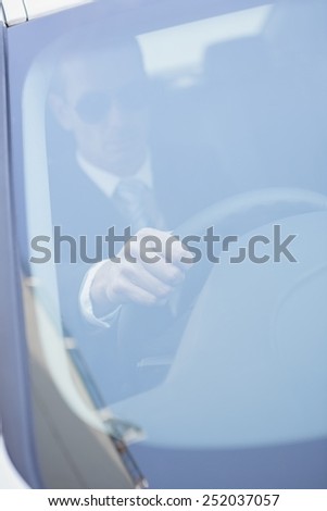 Businessman in the drivers seat in his car