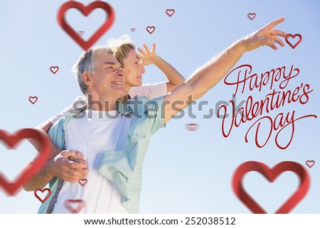 Happy senior man giving his partner a piggy back against happy valentines day