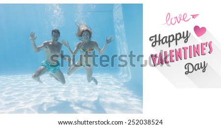 Cute couple smiling at camera underwater in the swimming pool against cute valentines message