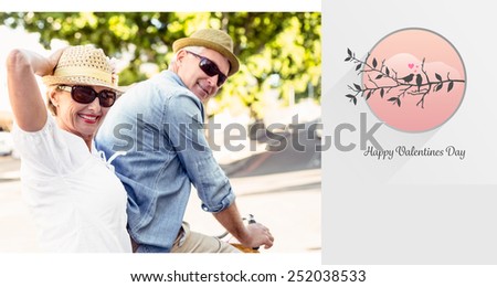 Happy mature couple going for a bike ride in the city against love birds