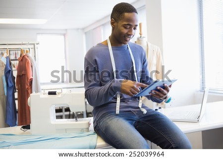 Smiling university student using tablet pc at the university