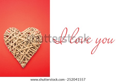 Wicker heart ornament against i love you