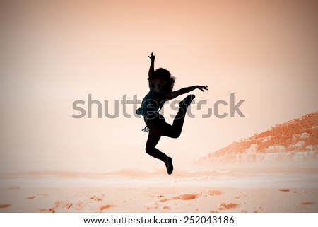 Pretty break dancer against beautiful beach and blue sky