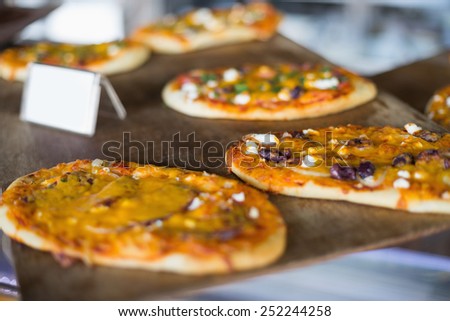 Cheesy pizza breads on tray in the delicatessen