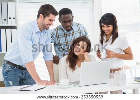 Happy teamwork using laptop together in the office