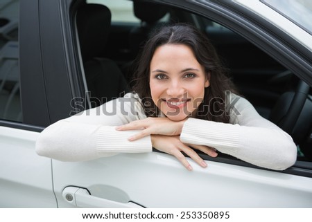 Happy woman in the drivers seat in her car