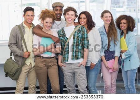Fashion students smiling at camera together at the college