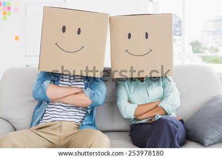 Coworkers with smiling face on couch in the office