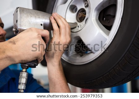 Mechanic adjusting the tire wheel at the repair garage