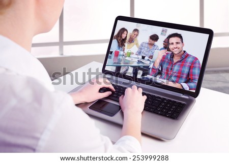 Businesswoman using her laptop against handsome designer sit in his office