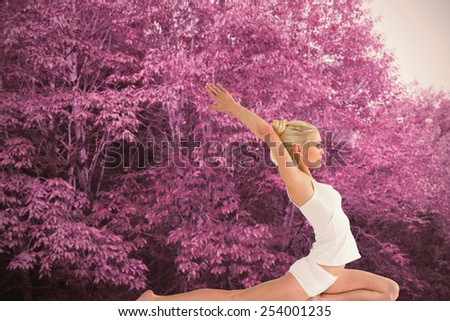 Toned young woman stretching hands backwards against peaceful autumn scene in forest