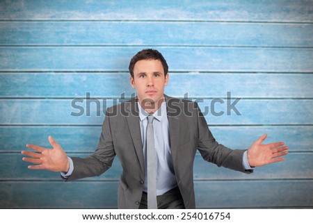 Businessman posing with hands out against wooden planks