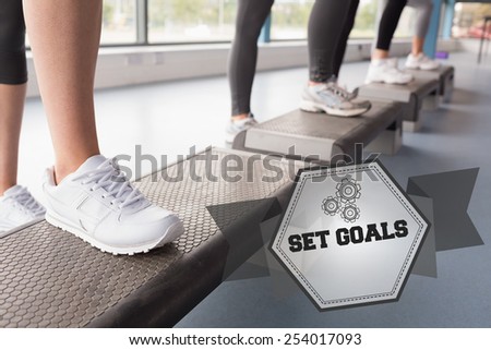 The word set goals and womens feet stepping in aerobics class against hexagon