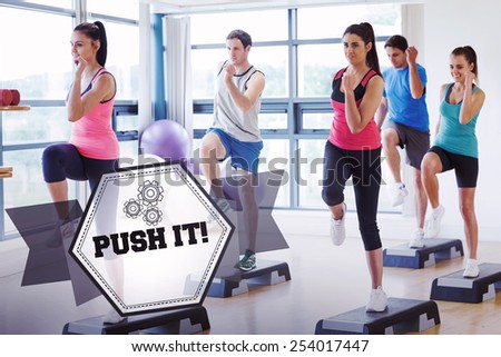 The word push it! and instructor with fitness class performing step aerobics exercise against hexagon