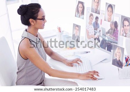 Editor holding tablet and smiling as team works behind her against profile pictures