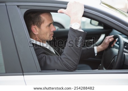 Focused businessman in the drivers seat in his car