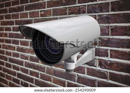 CCTV camera against red brick wall