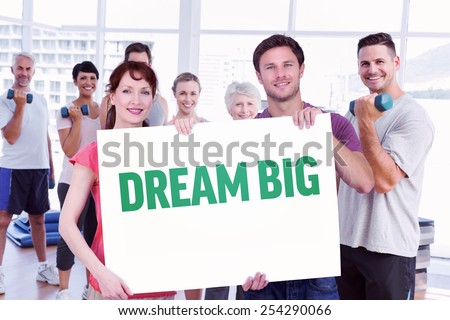 Couple holding a white sign against dream big