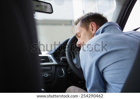 Drunk man slumped on steering wheel in his car