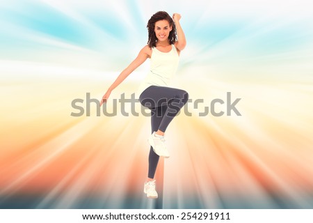 Fit woman doing aerobic exercise against abstract background