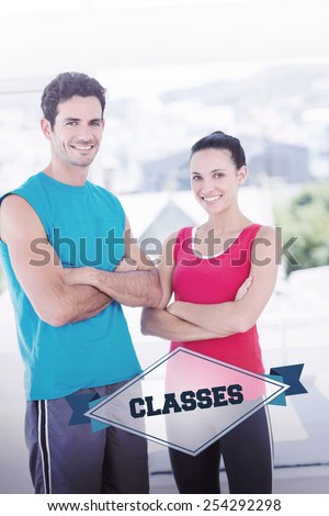 The word classes and fit couple with arms crossed in bright exercise room against badge