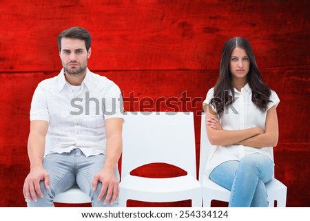 Angry couple not talking after argument against red wooden planks