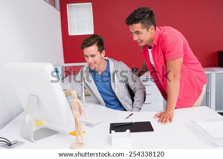 Students working together on computer at the college