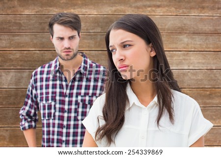Angry brunette not listening to her boyfriend against wooden planks background