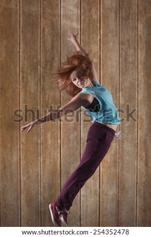 Pretty break dancer against wooden planks background