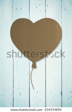 Heart balloon against painted blue wooden planks