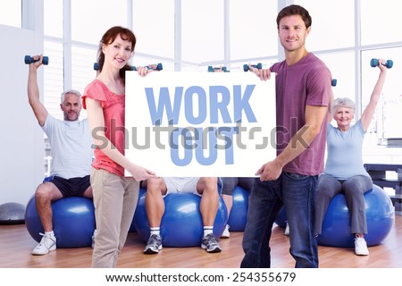 Couple holding a white sign against work out
