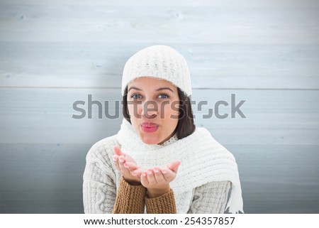 Brunette in warm clothing against bleached wooden planks background