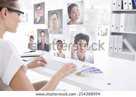 Female photo editor working on computer against profile pictures